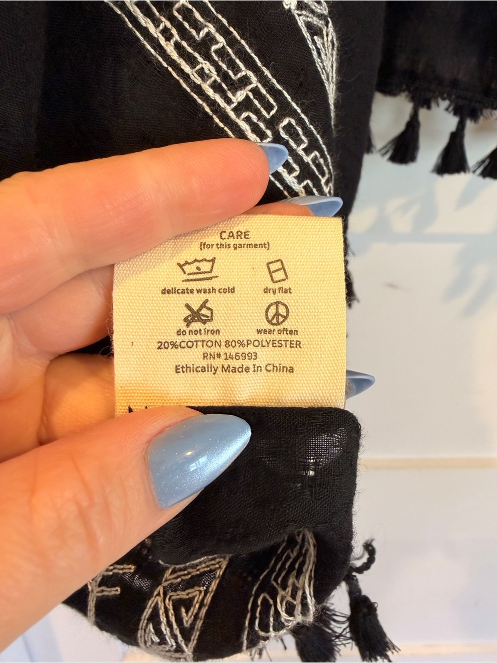 Three Bird Nest Black Poncho with White Geometric Trim - Picture 5 of 5